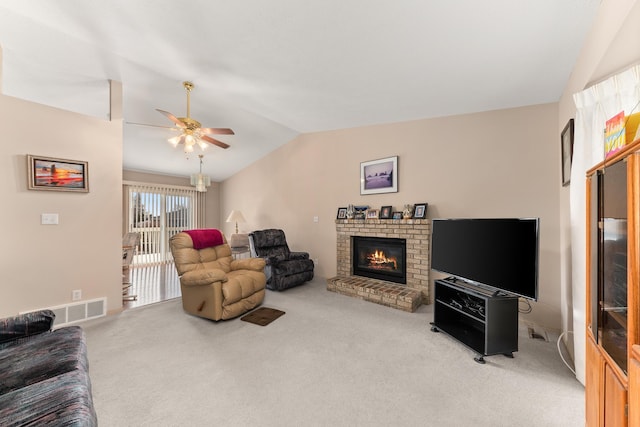 living area featuring visible vents, a ceiling fan, carpet, a fireplace, and lofted ceiling