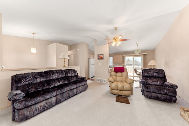 living room featuring lofted ceiling, carpet flooring, visible vents, and ceiling fan