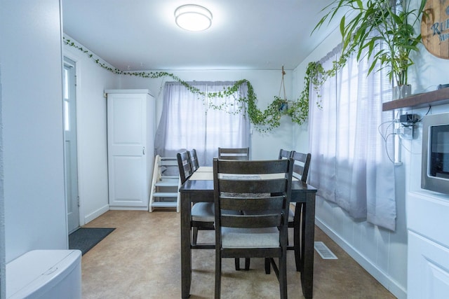 dining area with plenty of natural light, baseboards, and visible vents