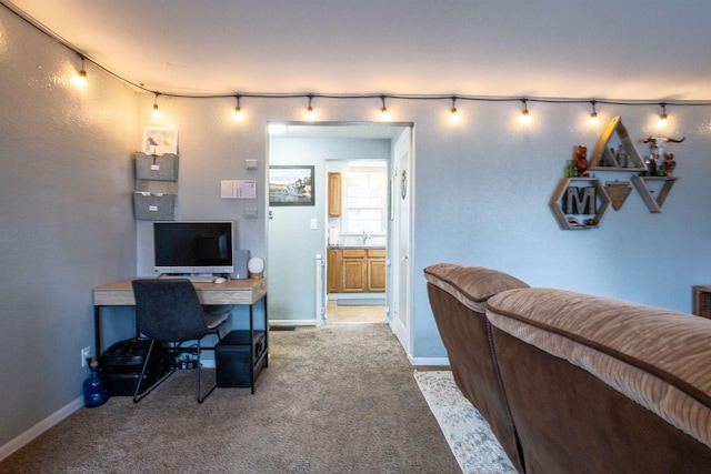 carpeted office featuring baseboards