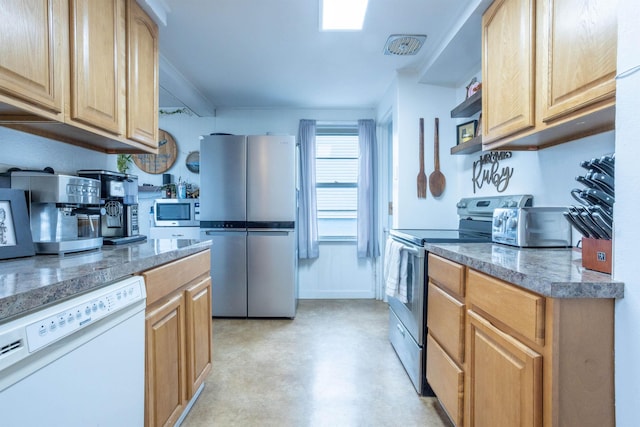 kitchen featuring concrete floors, appliances with stainless steel finishes, tile counters, and light brown cabinetry