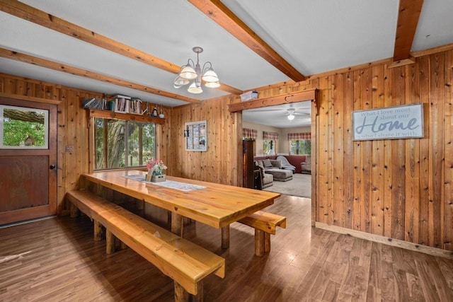 dining area featuring beam ceiling, plenty of natural light, wood finished floors, and a chandelier