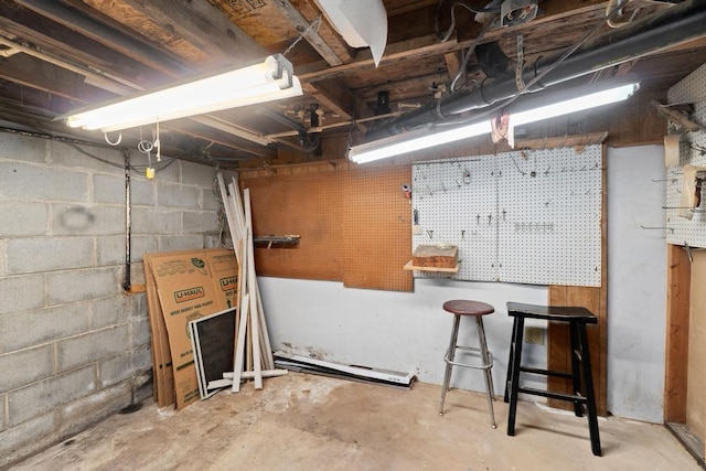 unfinished basement featuring a workshop area