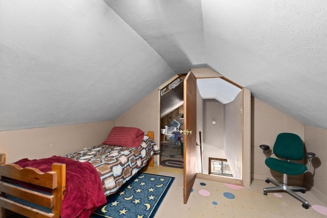 bedroom featuring lofted ceiling and a textured ceiling