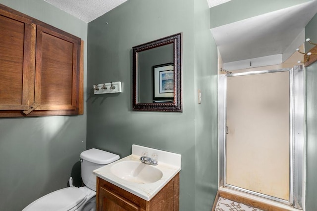 full bath with toilet, a stall shower, vanity, and a textured ceiling