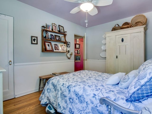 bedroom with a ceiling fan and wood finished floors