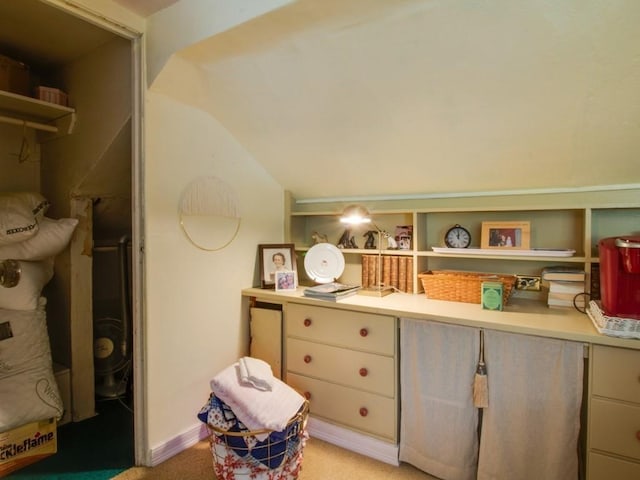 bedroom with light carpet and lofted ceiling