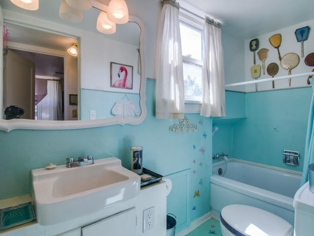 full bathroom featuring vanity, toilet, and a bathing tub