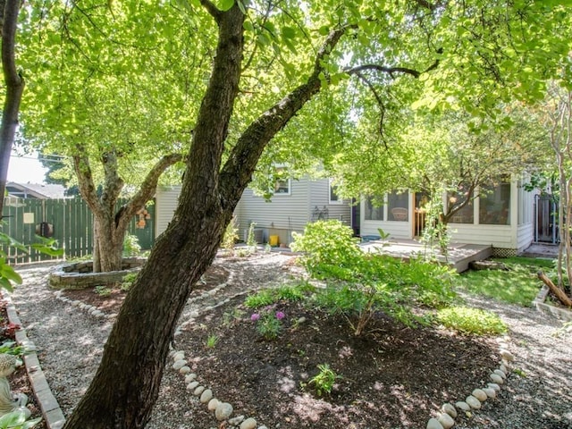 view of yard featuring a sunroom and fence