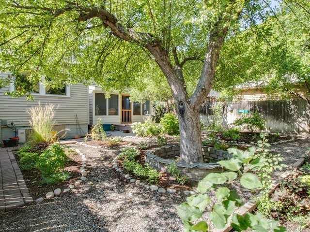 view of yard with a sunroom and fence