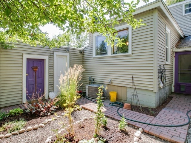 view of side of home featuring central air condition unit