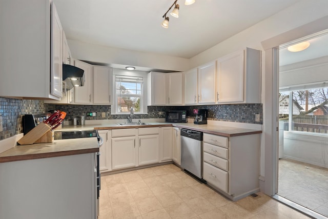 kitchen featuring a sink, black microwave, stainless steel dishwasher, exhaust hood, and backsplash