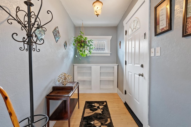 doorway to outside with light wood-style flooring