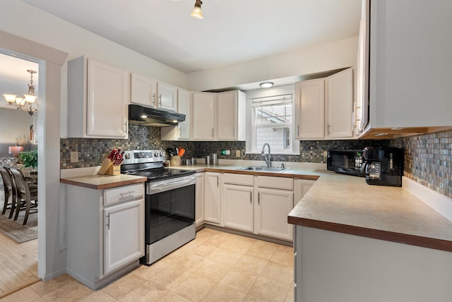 kitchen with under cabinet range hood, tasteful backsplash, stainless steel electric range, and a sink