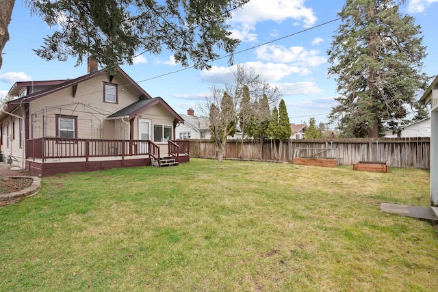 view of yard featuring a wooden deck and fence