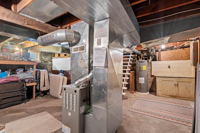 utility room featuring visible vents and electric water heater