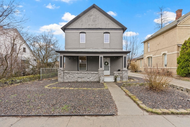 view of front of house with brick siding and covered porch