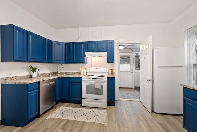 kitchen featuring white appliances, light wood finished floors, blue cabinetry, light countertops, and under cabinet range hood