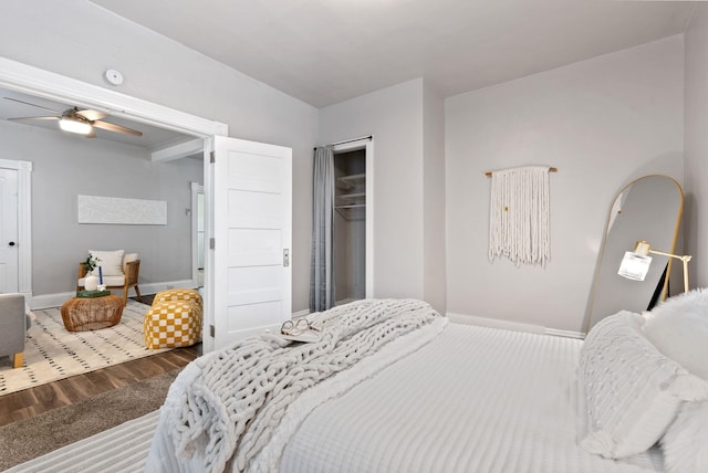 bedroom featuring a closet, baseboards, and wood finished floors