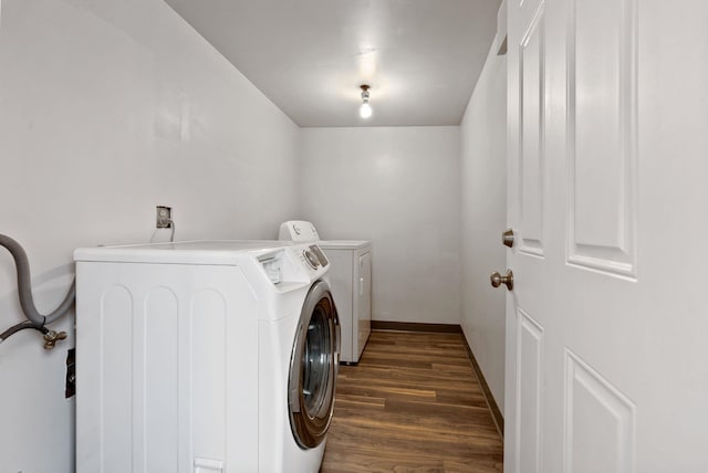 laundry area featuring washer and dryer, baseboards, dark wood-style floors, and laundry area