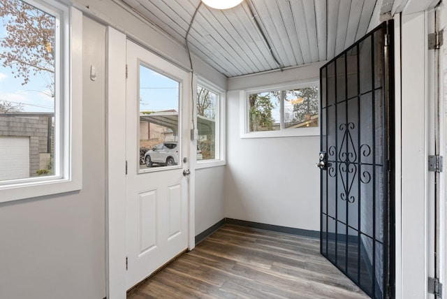 interior space featuring baseboards, wooden ceiling, and dark wood-style flooring