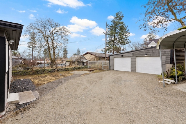 exterior space featuring fence and dirt driveway