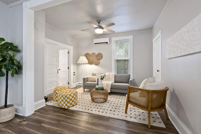 living area with baseboards, an AC wall unit, dark wood-type flooring, and a ceiling fan