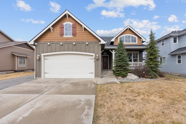 view of front of property with an attached garage, board and batten siding, a porch, a front yard, and driveway