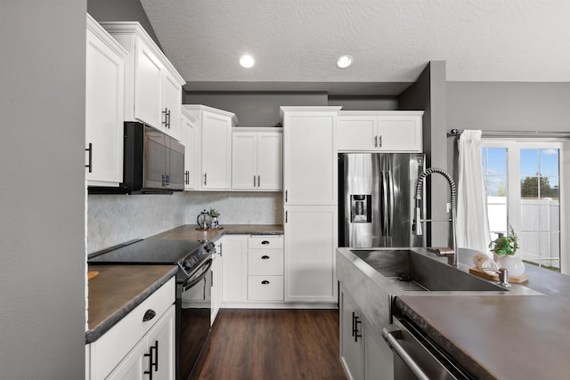 kitchen featuring a sink, black appliances, white cabinets, dark wood-type flooring, and dark countertops