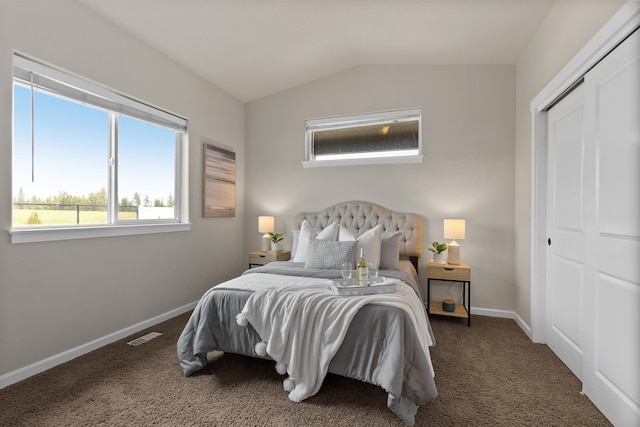 carpeted bedroom featuring a closet, visible vents, baseboards, and lofted ceiling