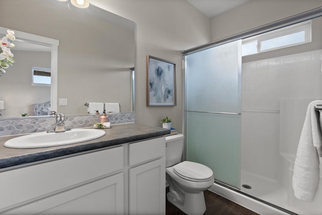 full bath with an enclosed shower, toilet, vanity, and wood finished floors