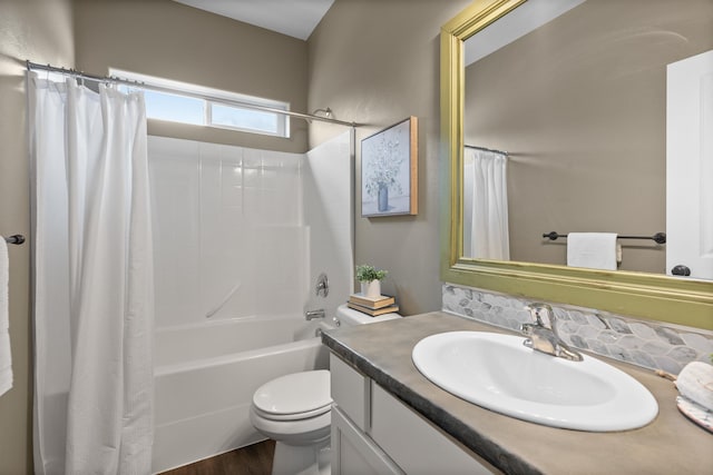 bathroom featuring shower / tub combo with curtain, toilet, and vanity