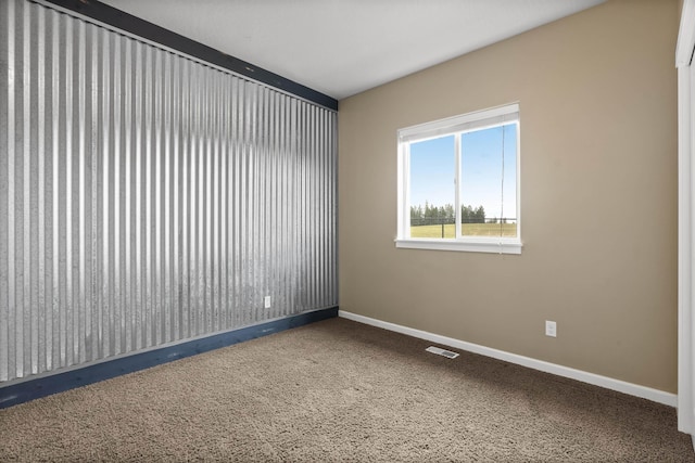 empty room featuring visible vents and baseboards