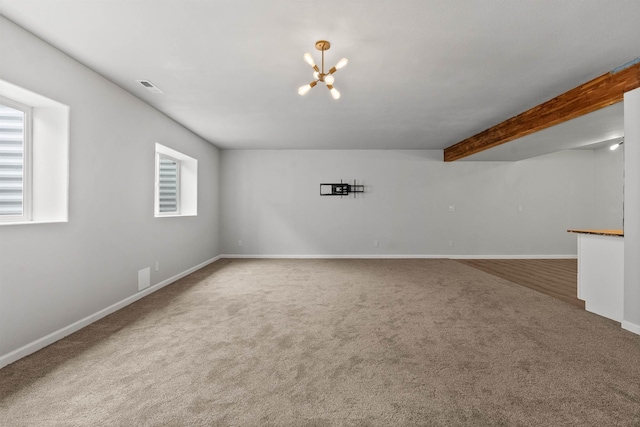 carpeted spare room with beam ceiling, visible vents, baseboards, and an inviting chandelier