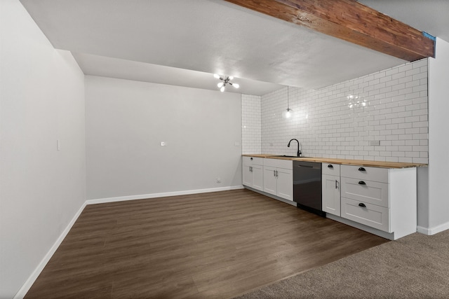 kitchen featuring butcher block countertops, a sink, backsplash, stainless steel dishwasher, and dark wood-style flooring