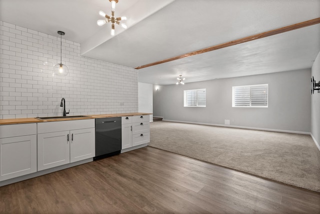 kitchen featuring a sink, tasteful backsplash, an inviting chandelier, butcher block counters, and dishwasher