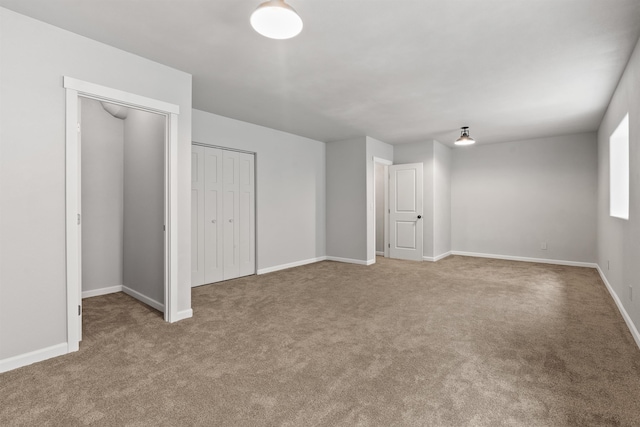 interior space with baseboards and carpet floors