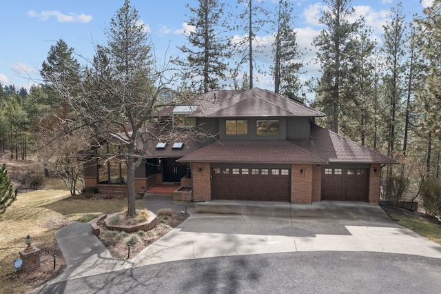 view of front of house featuring brick siding, concrete driveway, an attached garage, and a shingled roof