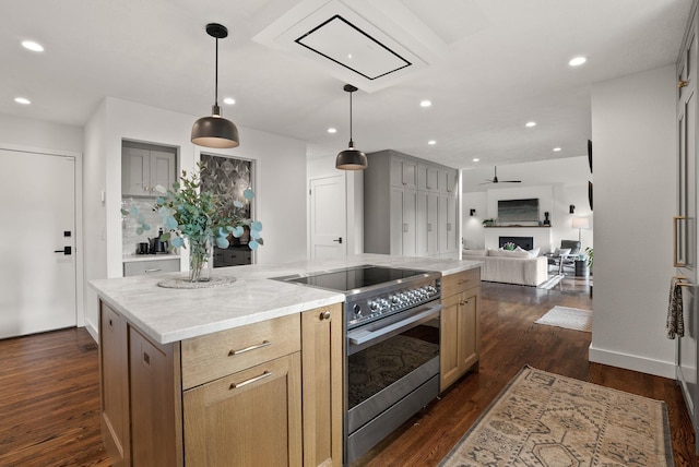 kitchen featuring electric stove, light stone counters, open floor plan, a center island, and dark wood-style flooring