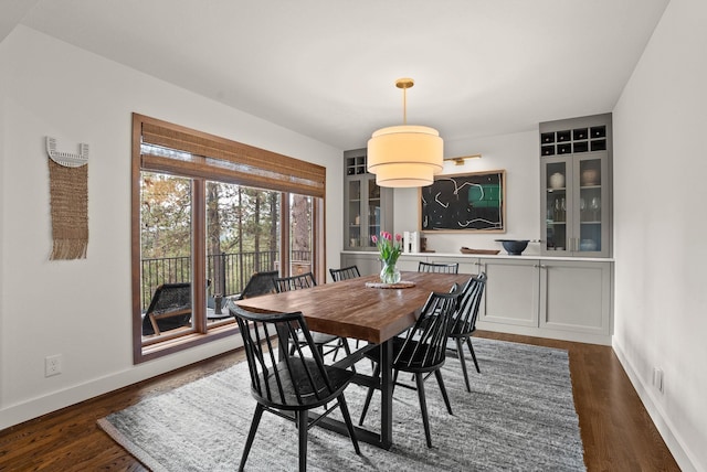 dining room featuring baseboards and dark wood-style flooring