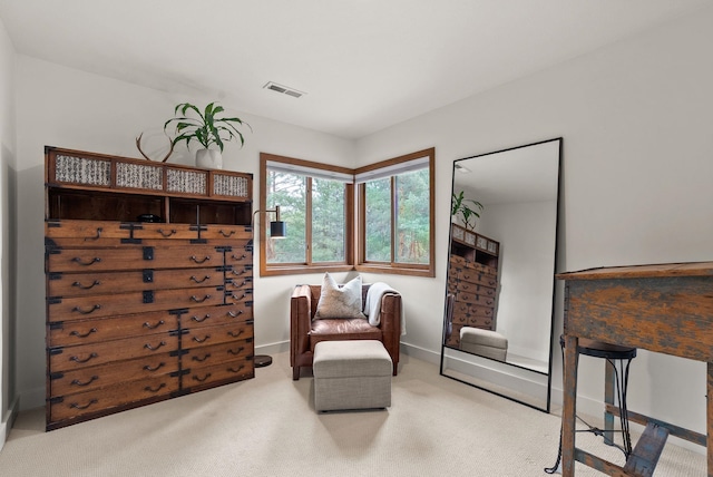 living area featuring visible vents, baseboards, and carpet