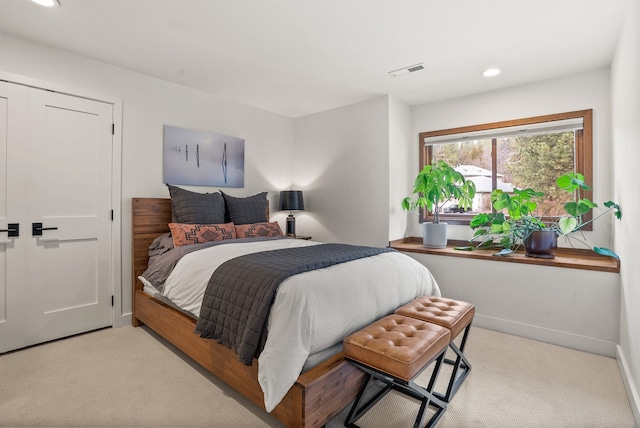 carpeted bedroom featuring recessed lighting, visible vents, and baseboards