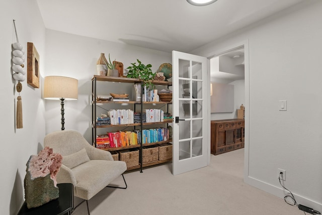 sitting room featuring baseboards and carpet