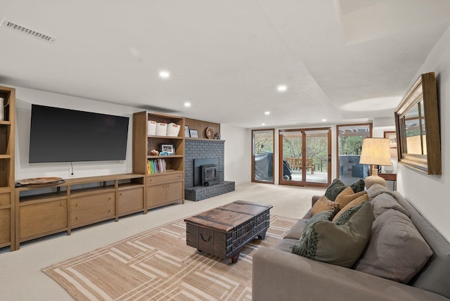 living room featuring recessed lighting, light colored carpet, and visible vents