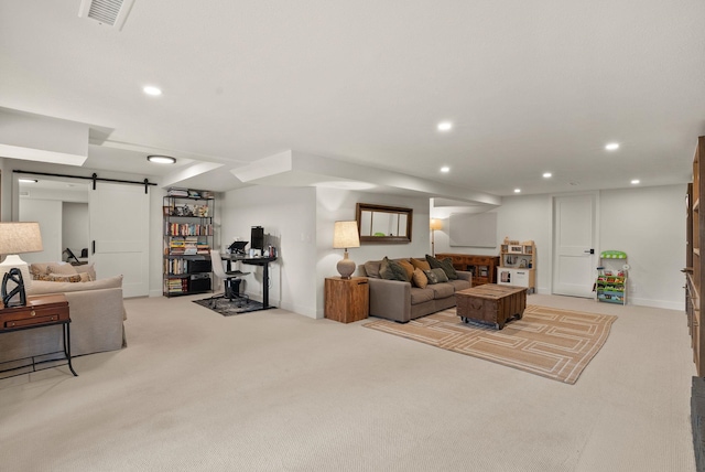 living area featuring recessed lighting, visible vents, a barn door, and light colored carpet