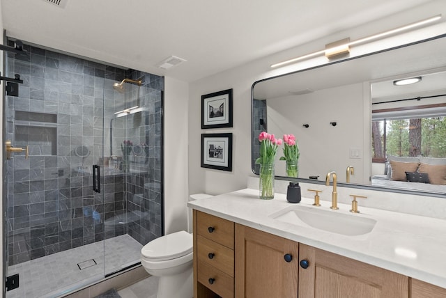 full bathroom with visible vents, vanity, toilet, and a shower stall