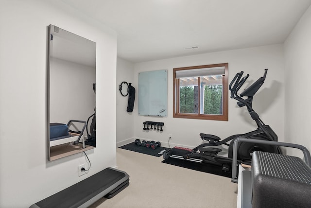 exercise area featuring visible vents, baseboards, and carpet floors