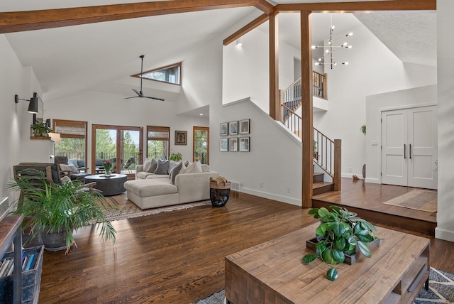 living room featuring visible vents, beam ceiling, wood finished floors, stairway, and ceiling fan