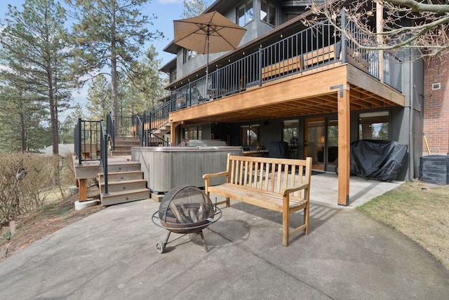 view of patio / terrace with a wooden deck, stairs, a fire pit, central air condition unit, and a grill