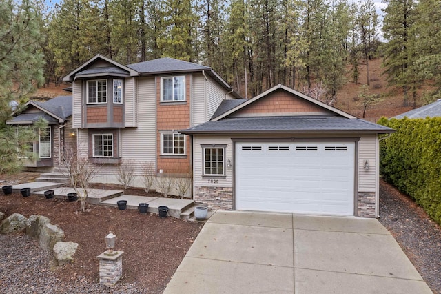 view of front facade with stone siding, roof with shingles, concrete driveway, and an attached garage